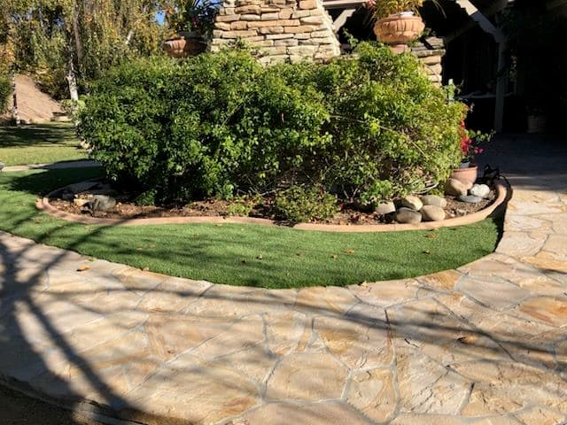 Backyard Oasis with Artificial Grass and Stone Paths image